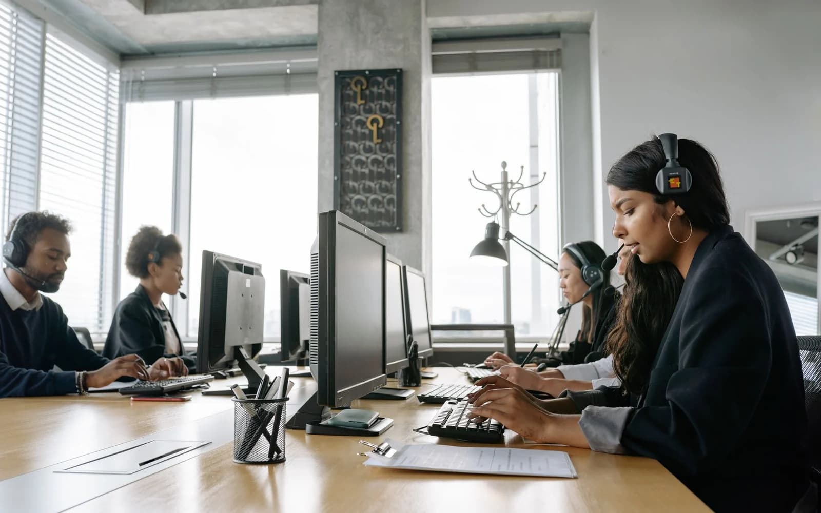 Representatives working at monitors in an office