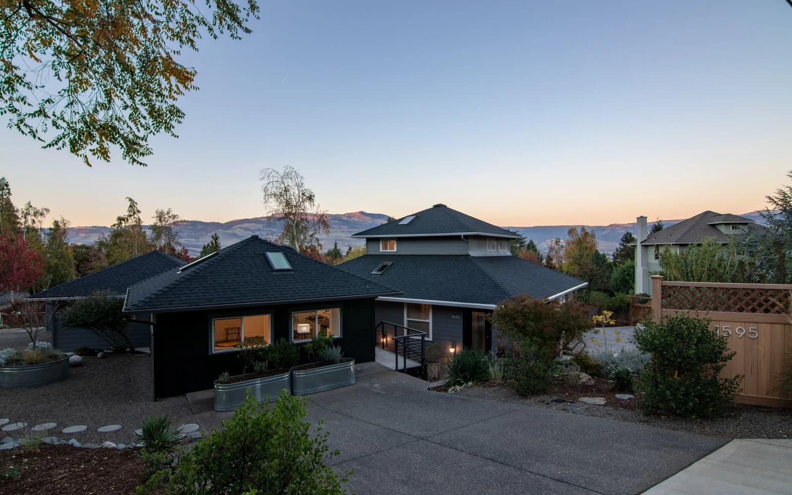 Residential homes at dusk with lights on