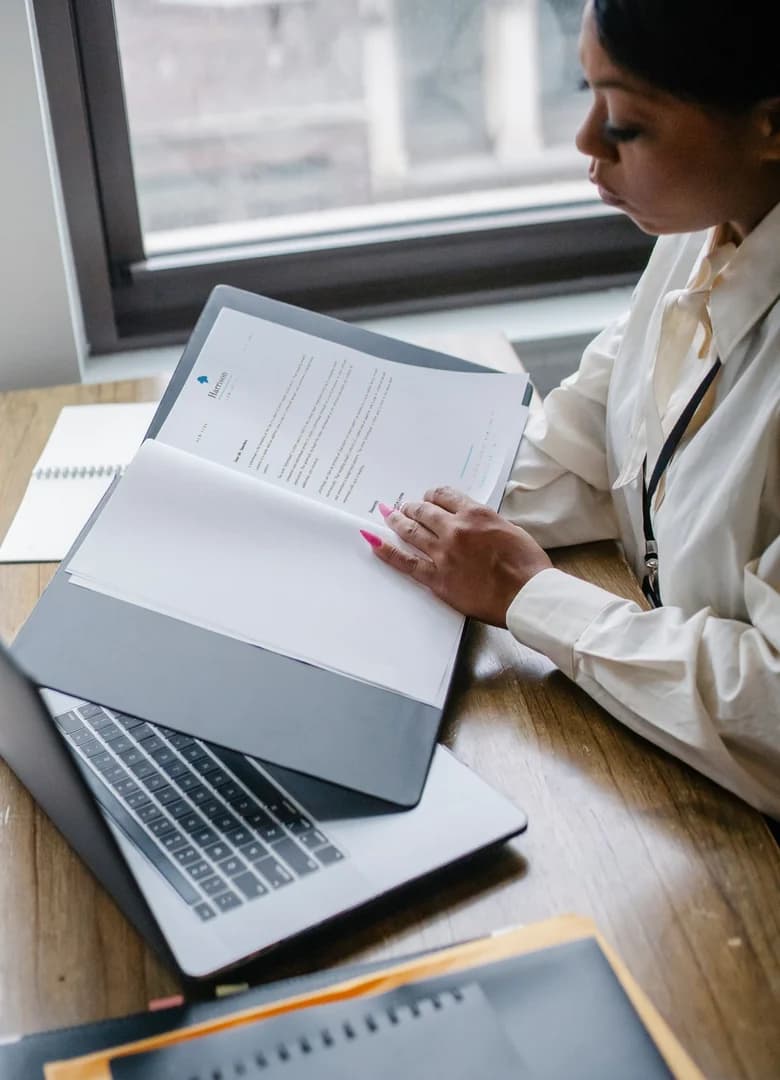 Person reviewing printed documents at a desk