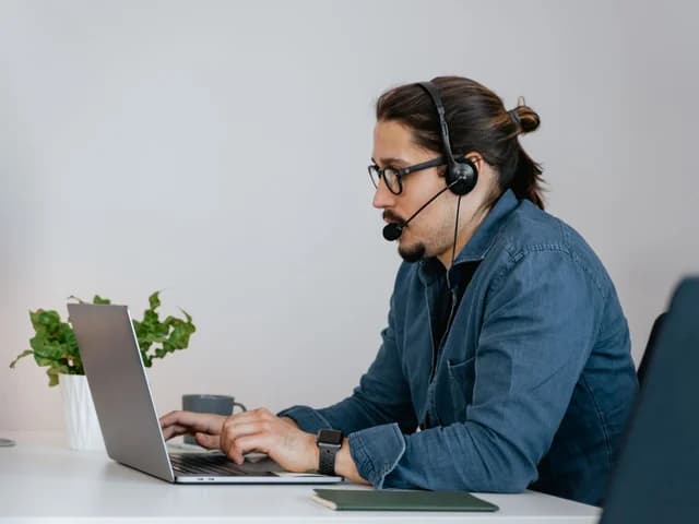 Representative on a headset call at a tidy desk