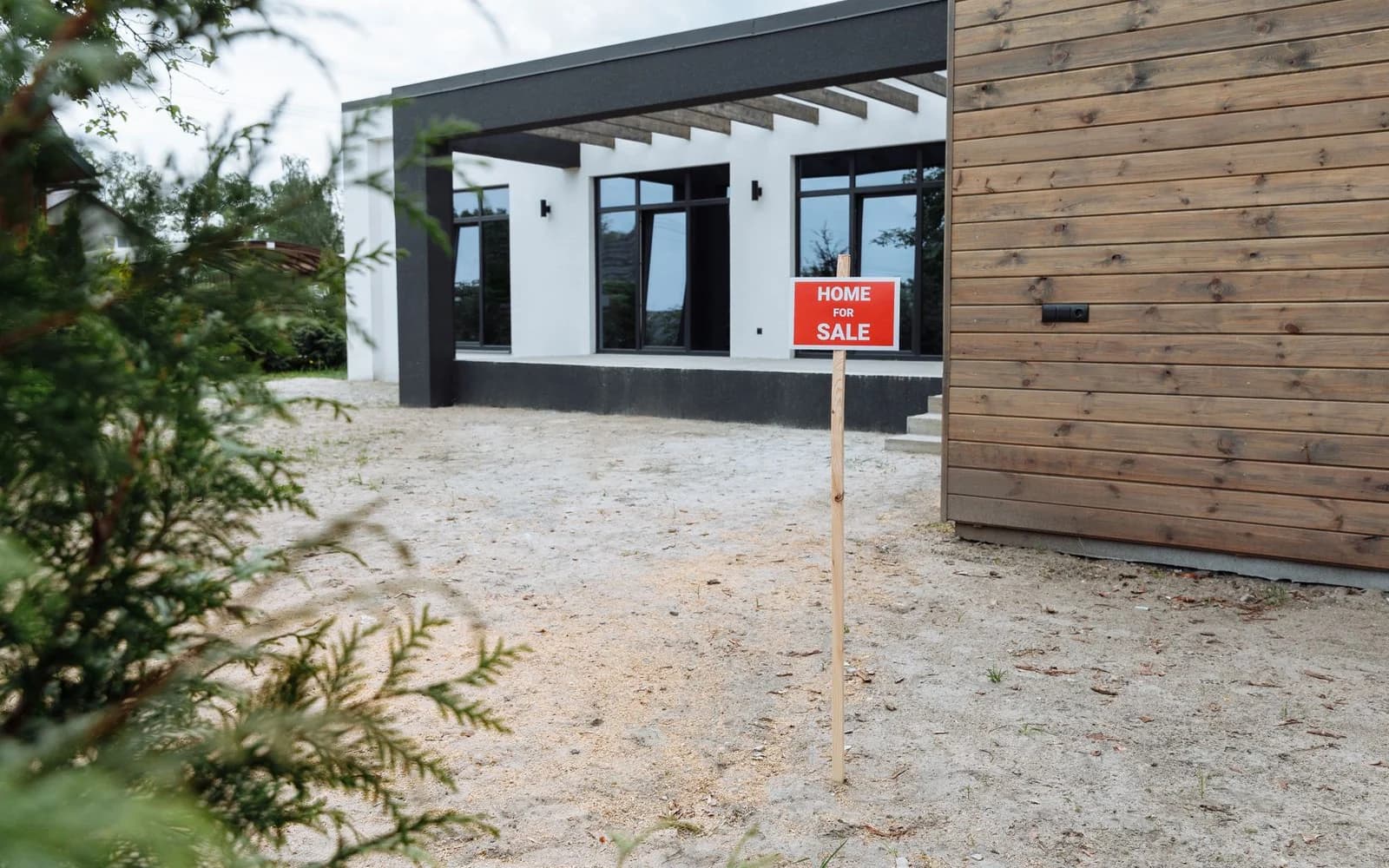 Modern house with a for-sale sign outside